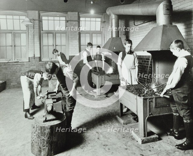 Boys using forges in a blacksmith's shop, Beaufoy Institute, London, 1911. Artist: Unknown.
