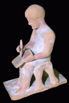 Greek terracotta of a man writing. Artist: Unknown