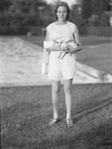 Rossbach, Miss, holding puppies, standing outdoors, 1932 June 30. Creator: Arnold Genthe.