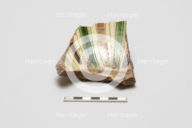 sherd, red body, white slip; green, brown, yellow striped glaze, Mamluk period, 1250-1516. Creator: Unknown.
