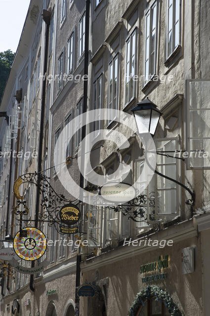 Detail view of the traditional signs along an old building on Getreidegasse, Salzburg, Austria, 2022 Creator: Ethel Davies.