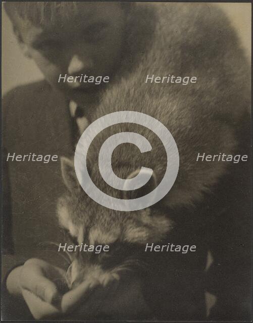 Portrait of a Boy Feeding a Raccoon, 1907-1943. Creator: Louis Fleckenstein.