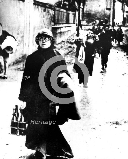 Refugees leaving a Normandy town, France, World War II, 1940-1944. Artist: Unknown