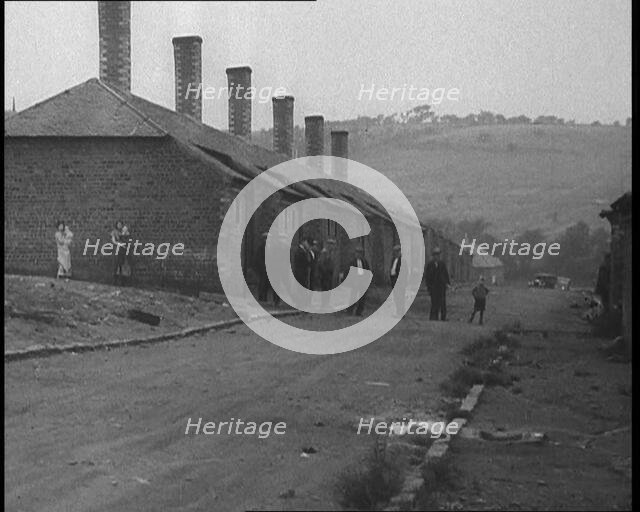 Group of Men, Women and Children Standing Around on a Street, 1933. Creator: British Pathe Ltd.
