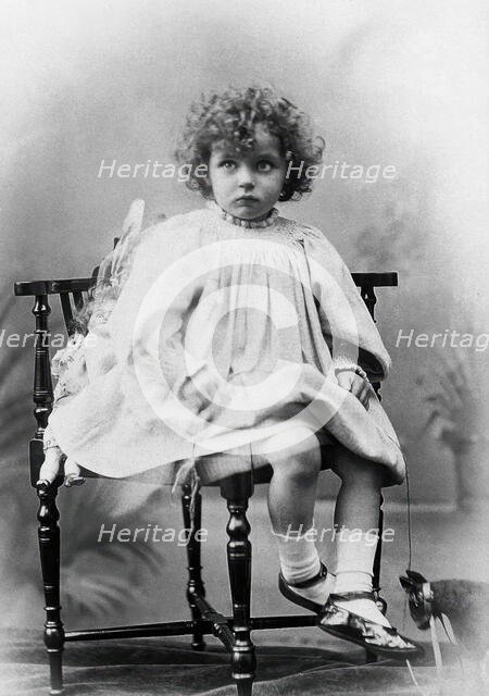 Nora Schuster aged 3, seated, facing forwards, c1895. Creator: Mrs Fred Wilkinson.
