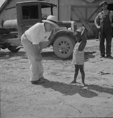 Plantation owner with one of the Negro plantation children, Aldridge Plantation, Mississippi, 1937. Creator: Dorothea Lange.