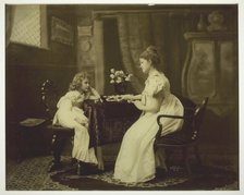 Woman and Child Playing Dominoes at Table, c. 1898. Creator: Unknown.