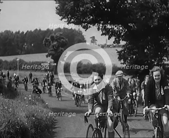 Large Group of Civilians Riding Bicycles Through Country Lanes, 1931. Creator: British Pathe Ltd.