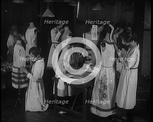 Young Female Civilians Sewing Dresses on Mannequins in an Arts Class, 1920. Creator: British Pathe Ltd.