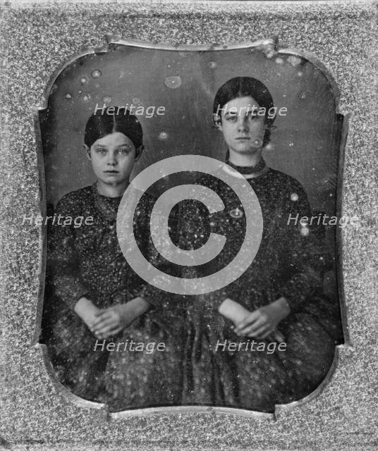 Group portrait of two unidentified girls, three-quarter length, seated, facing front, c1840 - 1860. Creator: Unknown.