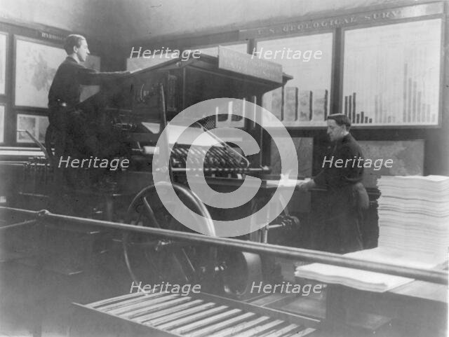 2 men operating map printing press at U.S. Geol. Survey, (1900?). Creator: Frances Benjamin Johnston.