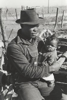 Negro sharecropper and son who will be resettled, Transylvania Project, Louisiana, Jan 1939. Creators: Farm Security Administration, Russell Lee.