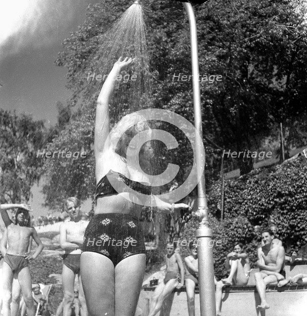 A refreshing shower during the heatwave in Stockholm, Sweden, 24th July 1943. Artist: Karl Sandels