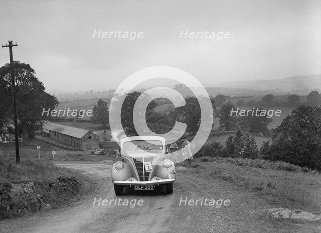 Ford V8 saloon competing in the South Wales Auto Club Welsh Rally, 1937 Artist: Bill Brunell.