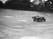 GL Baker's 5954 cc Minerva racing a 1930 Frazer-Nash Sportop on the banking at Brooklands. Artist: Bill Brunell.