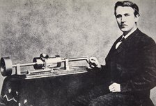 Thomas Alva Edison sitting beside his invention, the phonograph, 1878. Artist: Unknown