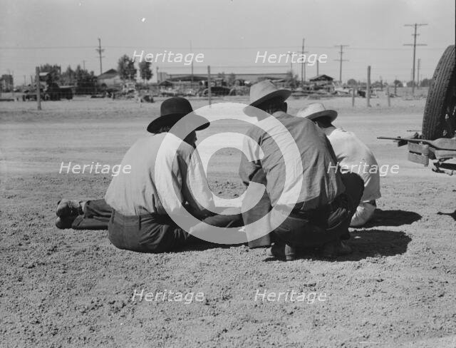 Oklahomans now working or looking for work in the pea harvests of California, Imperial Vallery, 1937 Creator: Dorothea Lange.