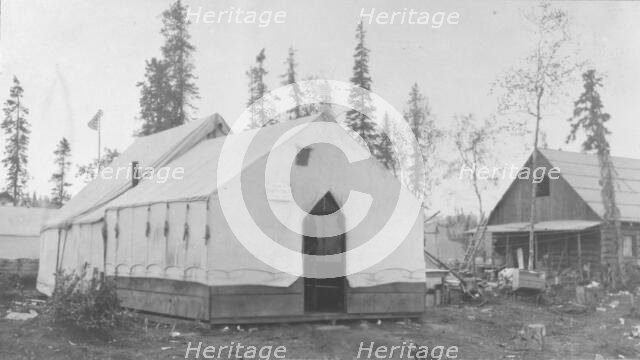 Tent next to log cabin, between c1900 and 1916. Creator: Unknown.