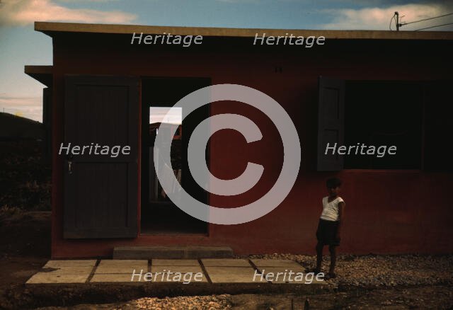 Child of an FSA - R.R. borrower? in front of their house, Puerto Rico, 1941 or 1942. Creator: Jack Delano.