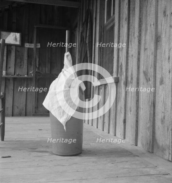 Pottery butter churn on porch of Negro tenant..., Randolph County, North Carolina, 1939. Creator: Dorothea Lange.