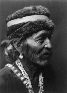 Navajo with fur cap, c1905. Creator: Edward Sheriff Curtis.
