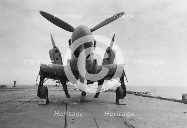 Fairey Firefly aircraft ready to be transported to the hangar lift, HMS 'Venerable', 1945. Artist: Unknown