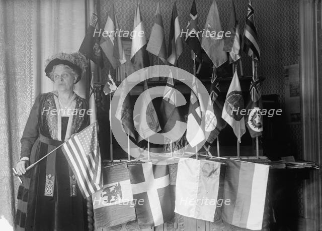 Mrs. Carrie Chapman Catt with Flags of 22 Nations, 1917. Creator: Harris & Ewing.