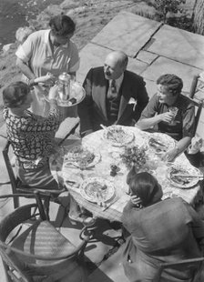 Mrs. Mary Benson and other people seated outdoors, 1933. Creator: Arnold Genthe.