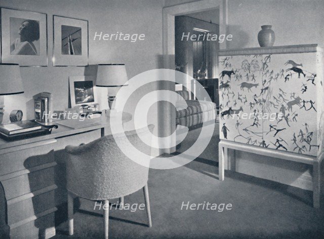 'W. & J. Sloane. Photographer's hobby room showing a desk in natural oak, a hand-woven covering on t Artist: Unknown.