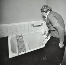16 Candy Street, Poplar, London: elderly woman in bathroom, 1962. Creator: Unknown.