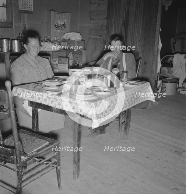 Mr. Wardlow says grace before dinner, Dead Ox Flat, Malheur County, Oregon, 1939. Creator: Dorothea Lange.