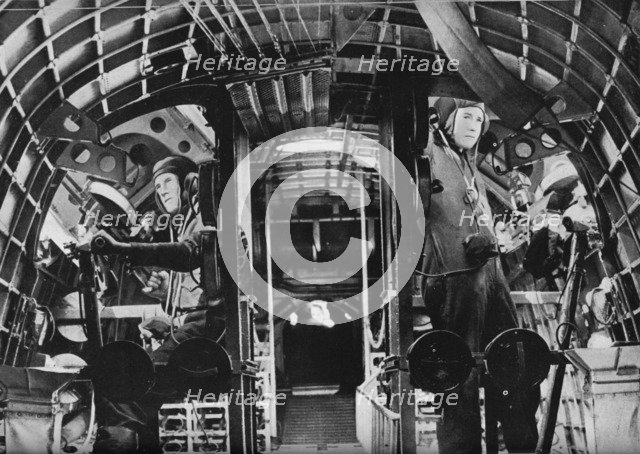 The midship gunners of an RAF flying boat alert at their stations, c1940 (1943). Artist: Unknown.