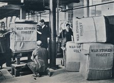 Packing the bales of khaki for despatch to the Government, c1914. Artist: Unknown