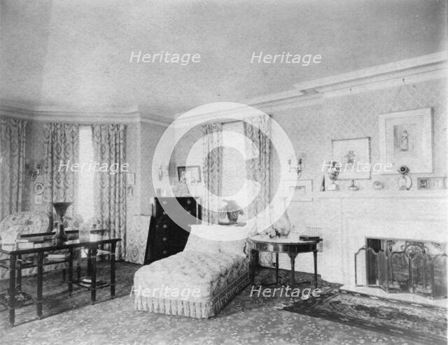 Bedroom with fireplace, and padded chaise longue, in home of...Greenwich, Connecticut, 1908. Creator: Frances Benjamin Johnston.