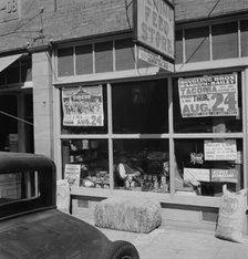 Feed store opposite bank, Tenino, Thurston County, Western Washington, 1939. Creator: Dorothea Lange.