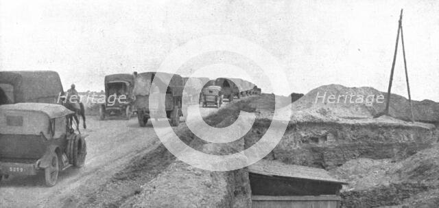 'Au Volant; Une route du front: arrivee des convois dans la zone avancee', 1918. Creator: Unknown.