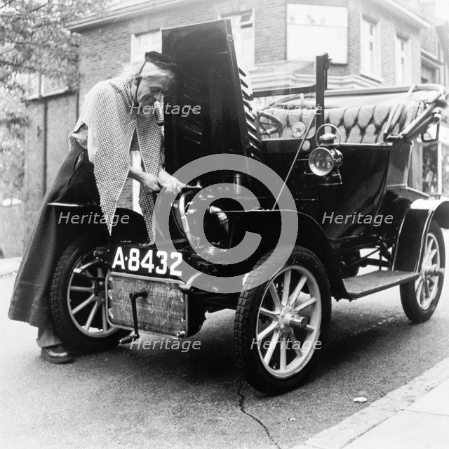 Man in fancy dress with a veteran car, London, (c1960-c1980?). Artist: Henry Grant