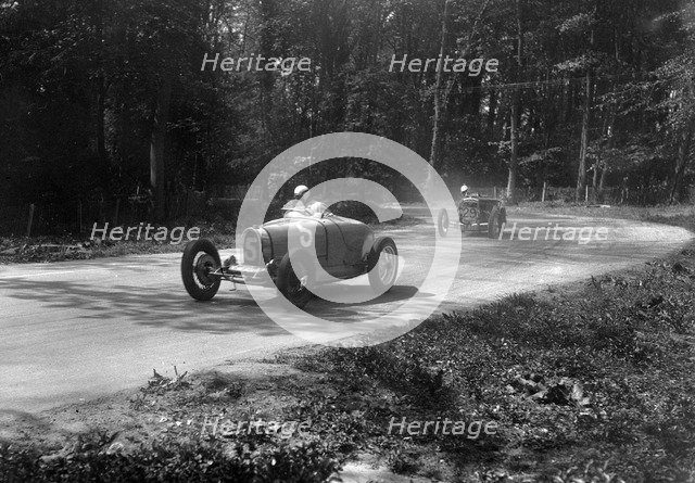 TP Cholmondeley-Tapper's Bugatti Type 37A leading a Frazer-Nash TT replica at Donington Park, 1930s. Artist: Bill Brunell.