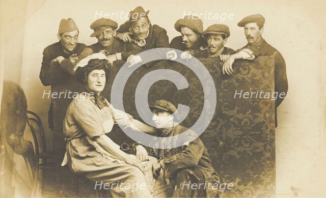 Actors gathered around a man in drag, between 1910 and 1919. Creator: Unknown.