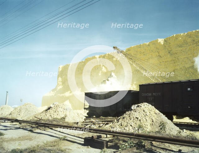 Loading box cars with sulphur, Freeport Sulphur Co., Hoskins Mound, Texas, 1943. Creator: John Vachon.