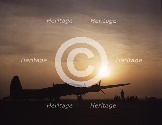 Sunset silhouette of flying fortress, Langley Field, Va., 1942. Creator: Alfred T Palmer.