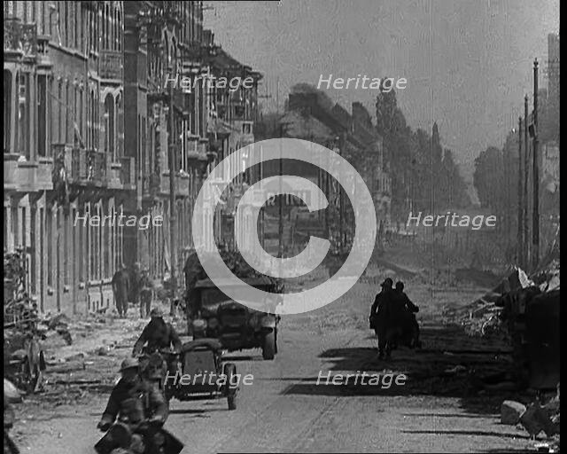 British Expeditionary Force Retreating Through Belgian Town on Vehicles, 1940. Creator: British Pathe Ltd.