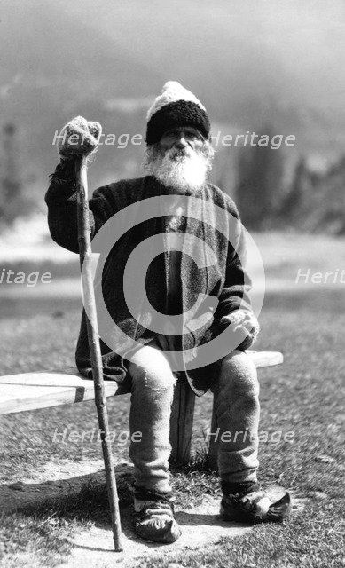 Old man sitting on a bench, Bistrita Valley, Moldavia, north-east Romania, c1920-c1945. Artist: Adolph Chevalier
