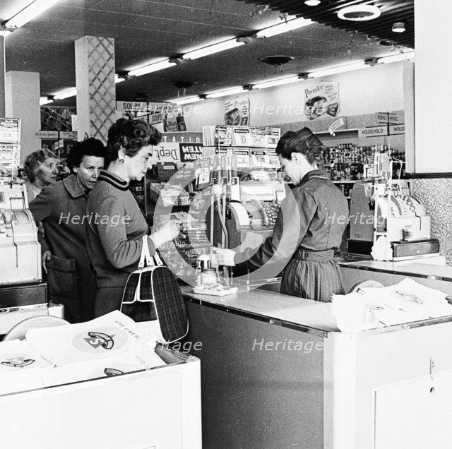 Shoppers at a checkout in a London supermarket, c1950s. Artist: Henry Grant