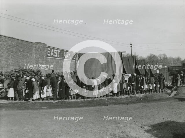 African Americans holding their pots and pans, and waiting for their turn to get meals, Feb. 1937. Creators: Farm Security Administration, Edwin Locke.