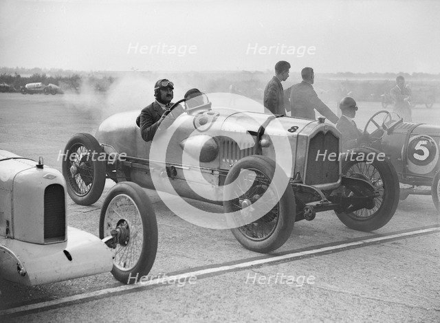 Riley, Buick and Bugatti on the start line at a Surbiton Motor Club race meeting, Brooklands, 1928. Artist: Bill Brunell.