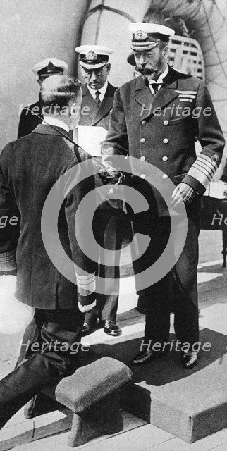 King George V knights Vice-Admiral Pakenham aboard HMS Princess Royal, c1930s. Artist: Unknown