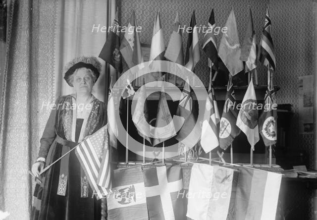 Mrs. Carrie Chapman Catt with Flags of 22 Nations, 1917. Creator: Harris & Ewing.