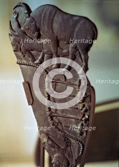 Fragment of an Egyptian palette with images of a bull fight. Made in schist.