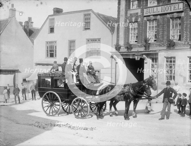Horse drawn bus with passengers outside the Bull Hotel, Burford High Street, Oxon, c1860-c1922. Artist: Henry Taunt